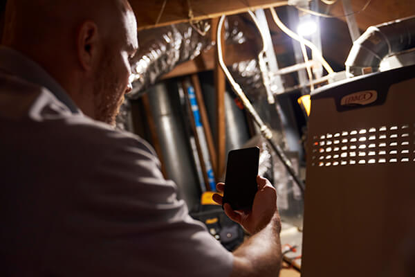 Comfort Zone technician servicing a Lennox furnace