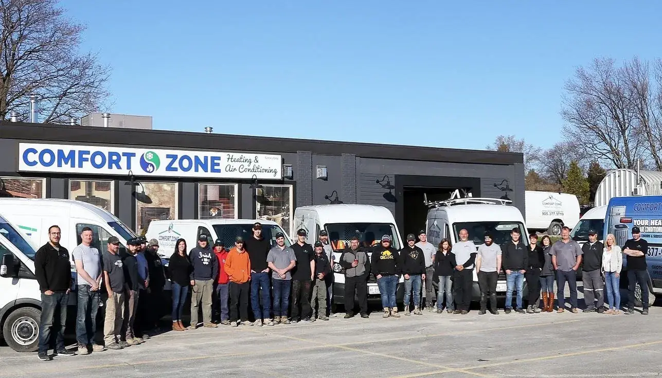 The Comfort Zone team in front of the Cobourg showroom and service vans